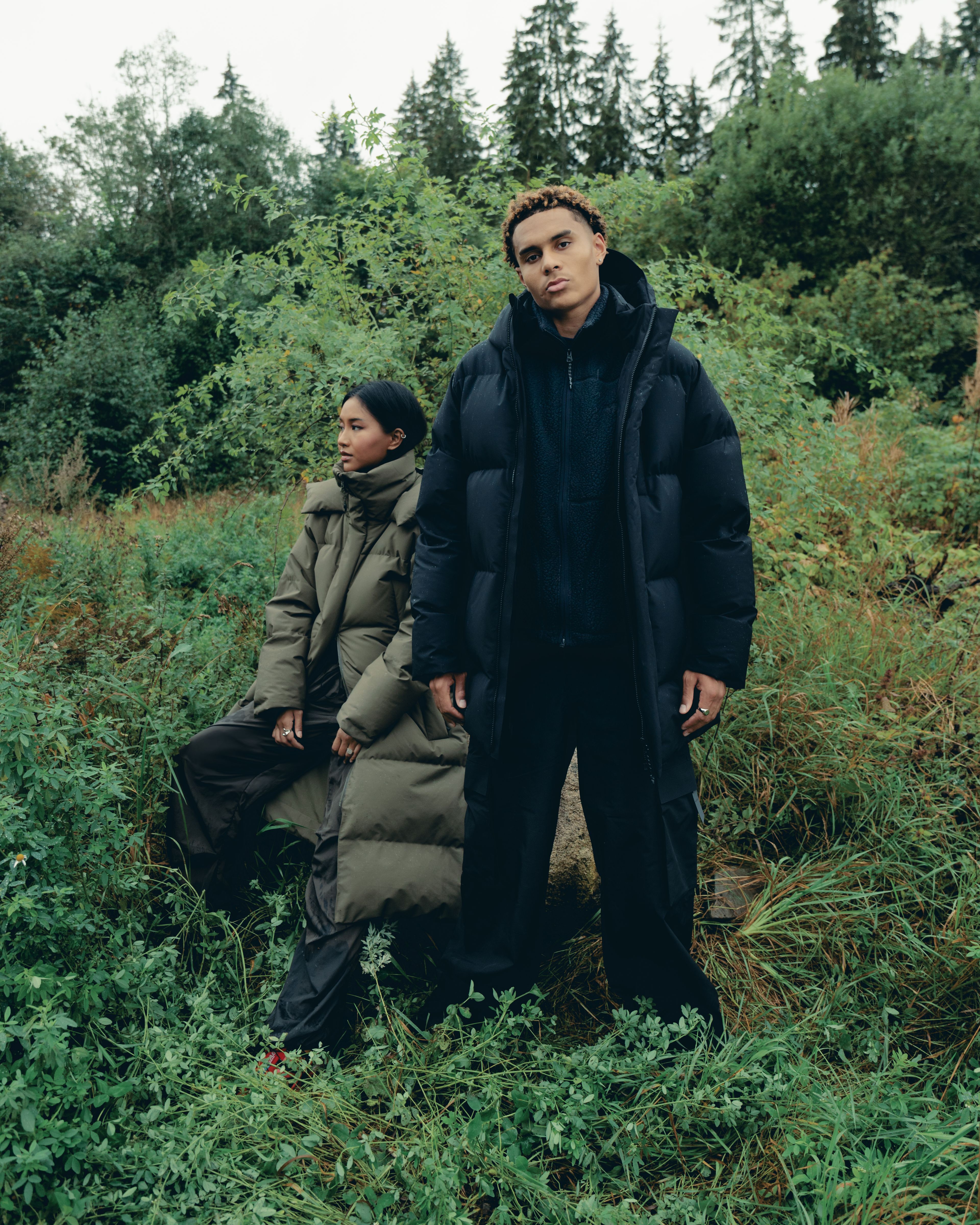 Man wearing the Ulla down jacket from BLÆST, with a woman wearing the Stranda down jacket from BLÆST