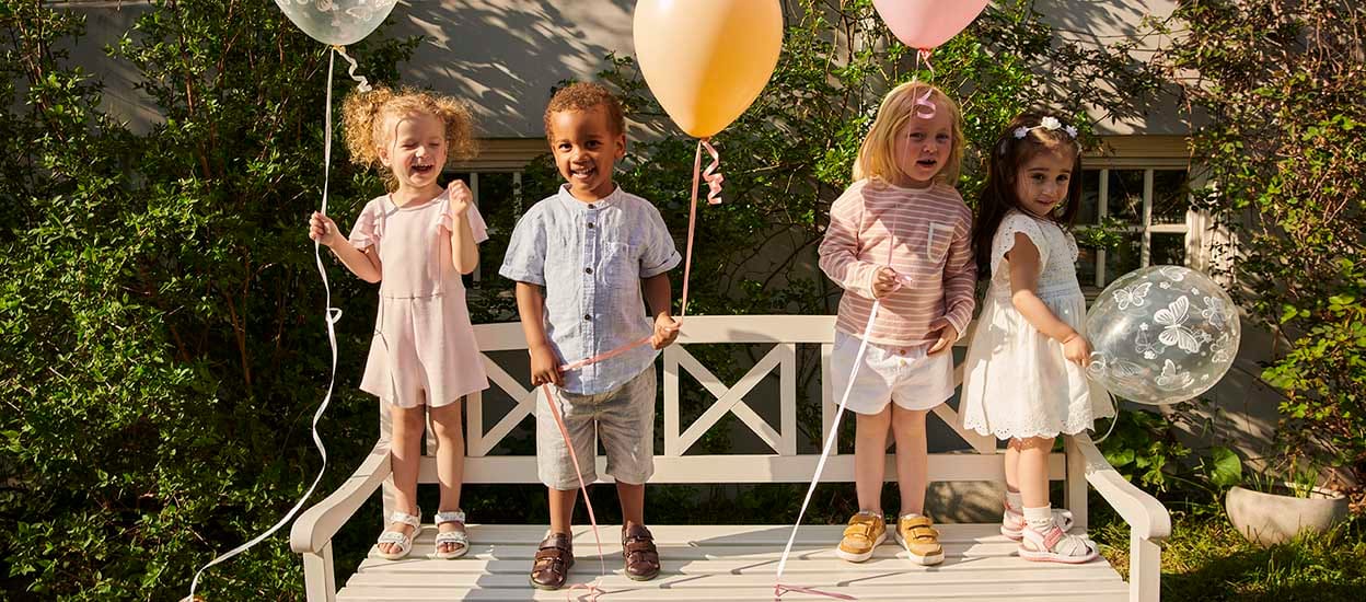 Kids at a birthday party in the summer, wearing Viking sandals