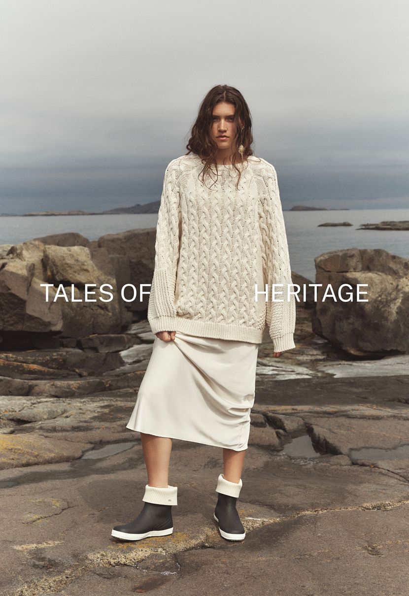 Woman by the sea, wearing iconic Viking Kadett rubber boots